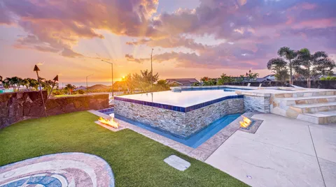 a view of a swimming pool and an outdoor seating