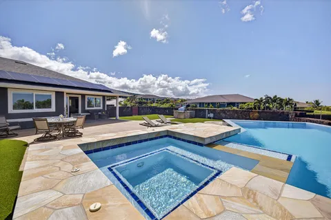 a living room with furniture a flat screen tv and a dining table