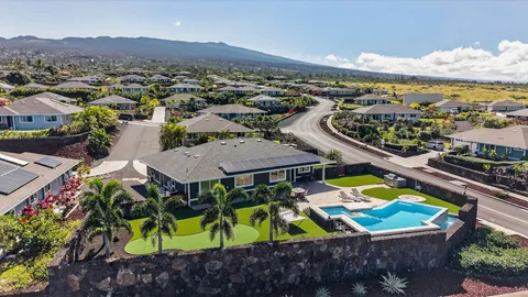 an aerial view of residential houses with outdoor space and swimming pool