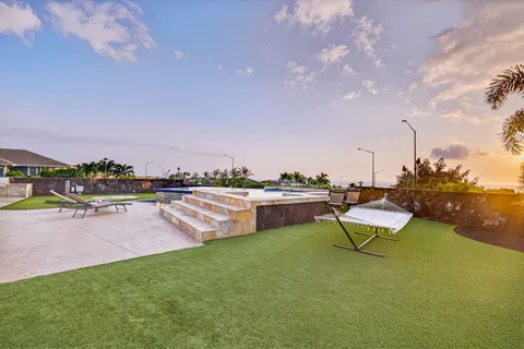 a swimming pool with outdoor seating and a garden