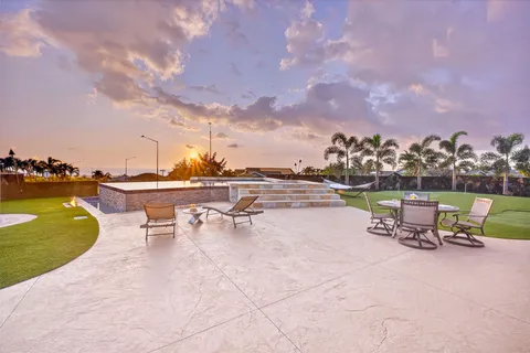 a view of swimming pool with outdoor seating and yard in back