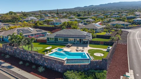 an aerial view of a house with a swimming pool yard and outdoor seating