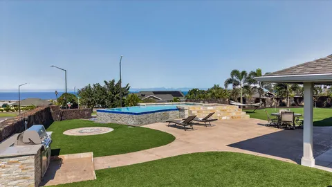 a view of a backyard with plants and patio