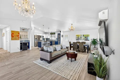 a living room with furniture and a chandelier