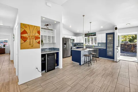 a kitchen with stainless steel appliances granite countertop a refrigerator and a stove top oven