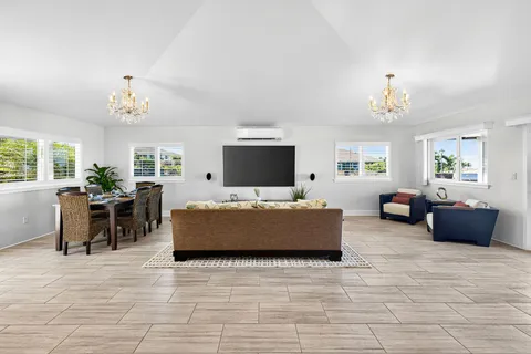 a living room with furniture and a chandelier