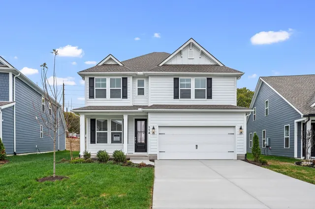 a front view of a house with a yard and garage