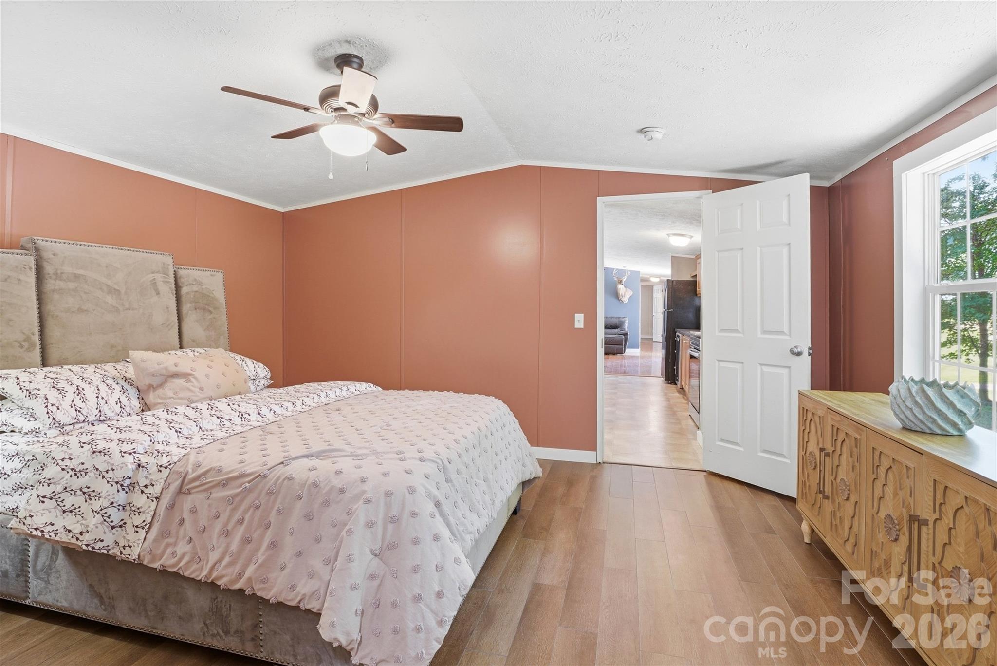 4406 Lucy Short Cut Road Marshville, NC 28103 - Photo 16 of 30 a bedroom with a bed and a chandelier