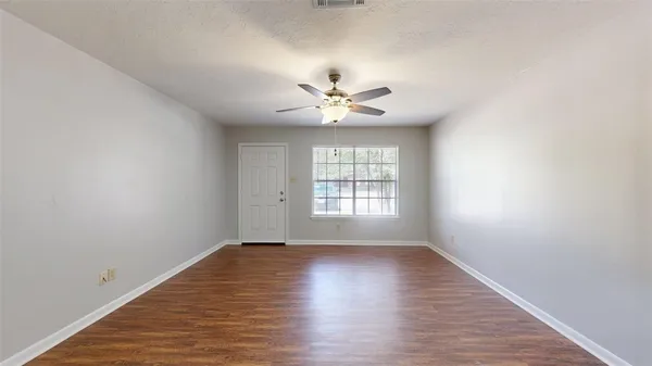 wooden floor in an empty room with a window