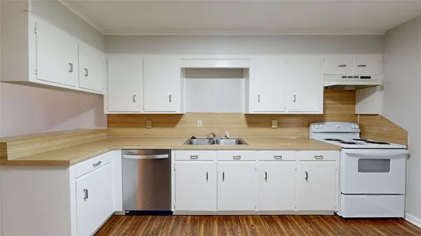 a kitchen with granite countertop white cabinets and white appliances