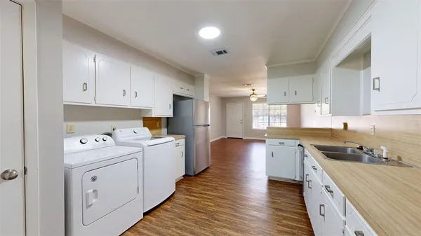 a kitchen with stove cabinets and wooden floor