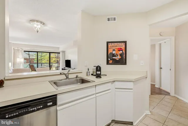 a kitchen with a sink and cabinets