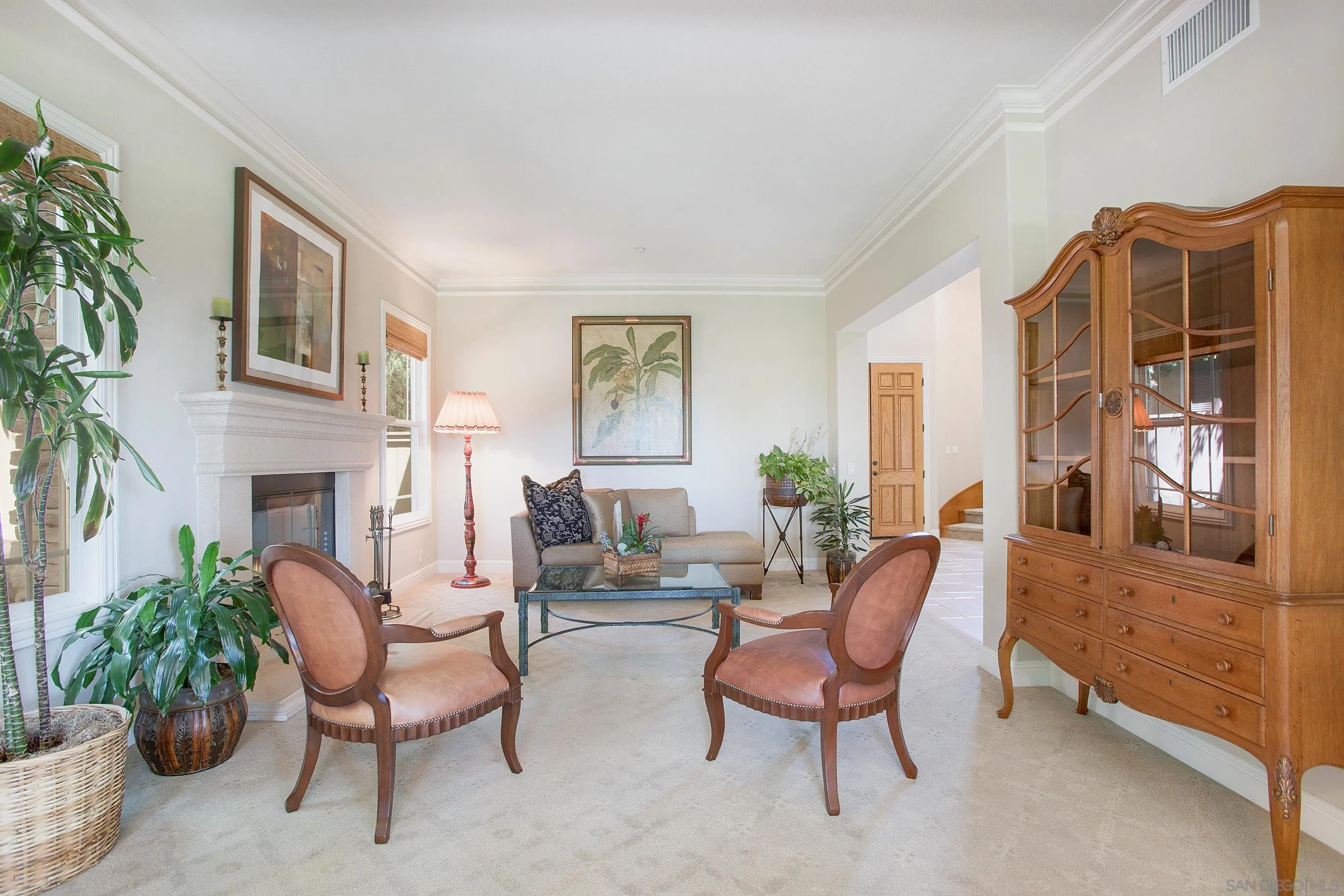 562 Shasta Drive Encinitas, CA 92024 - Photo 15 of 59 a living room with furniture a fireplace and a potted plant