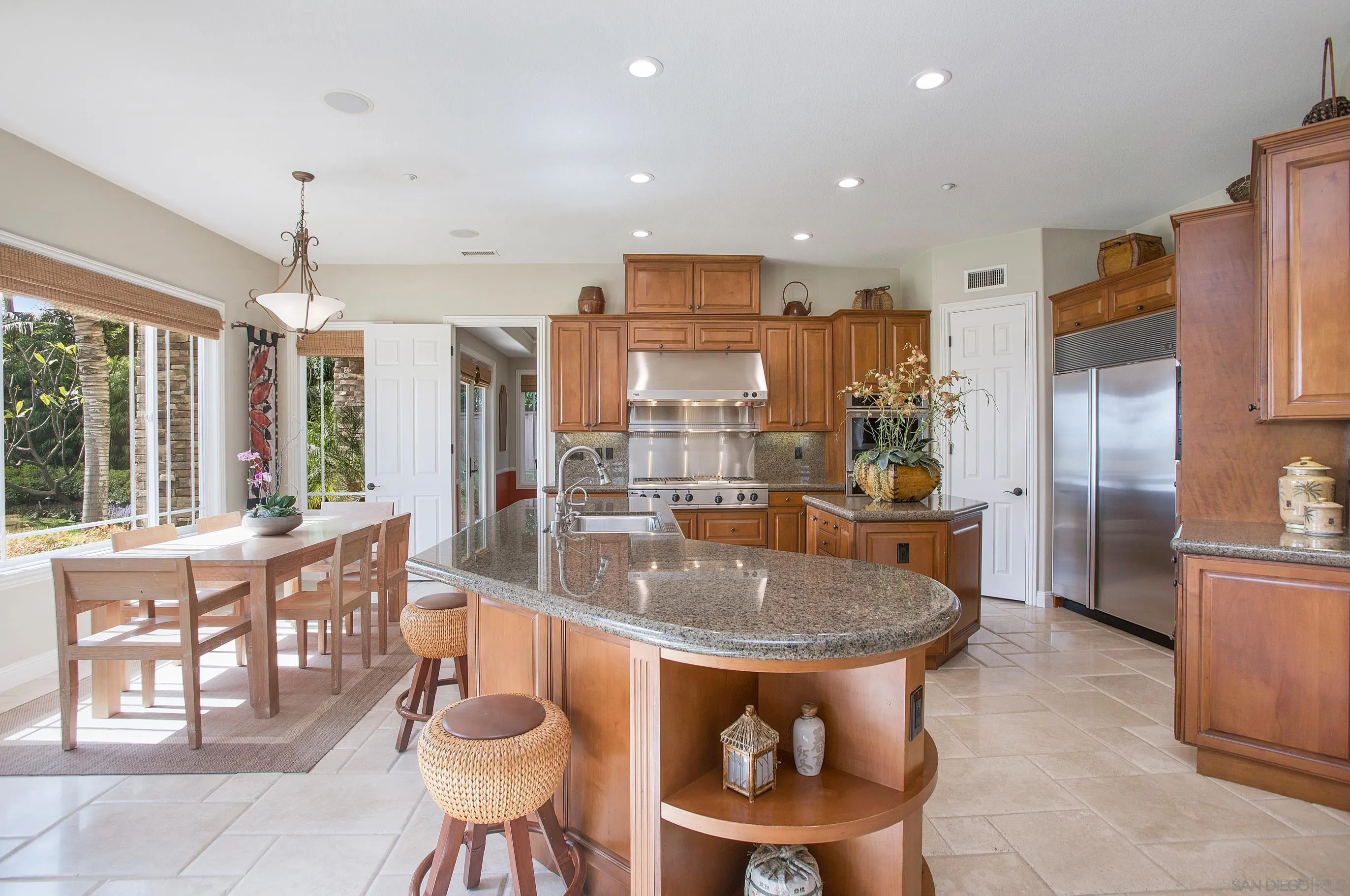 562 Shasta Drive Encinitas, CA 92024 - Photo 22 of 59 a kitchen with stainless steel appliances granite countertop a stove a refrigerator and a dining table