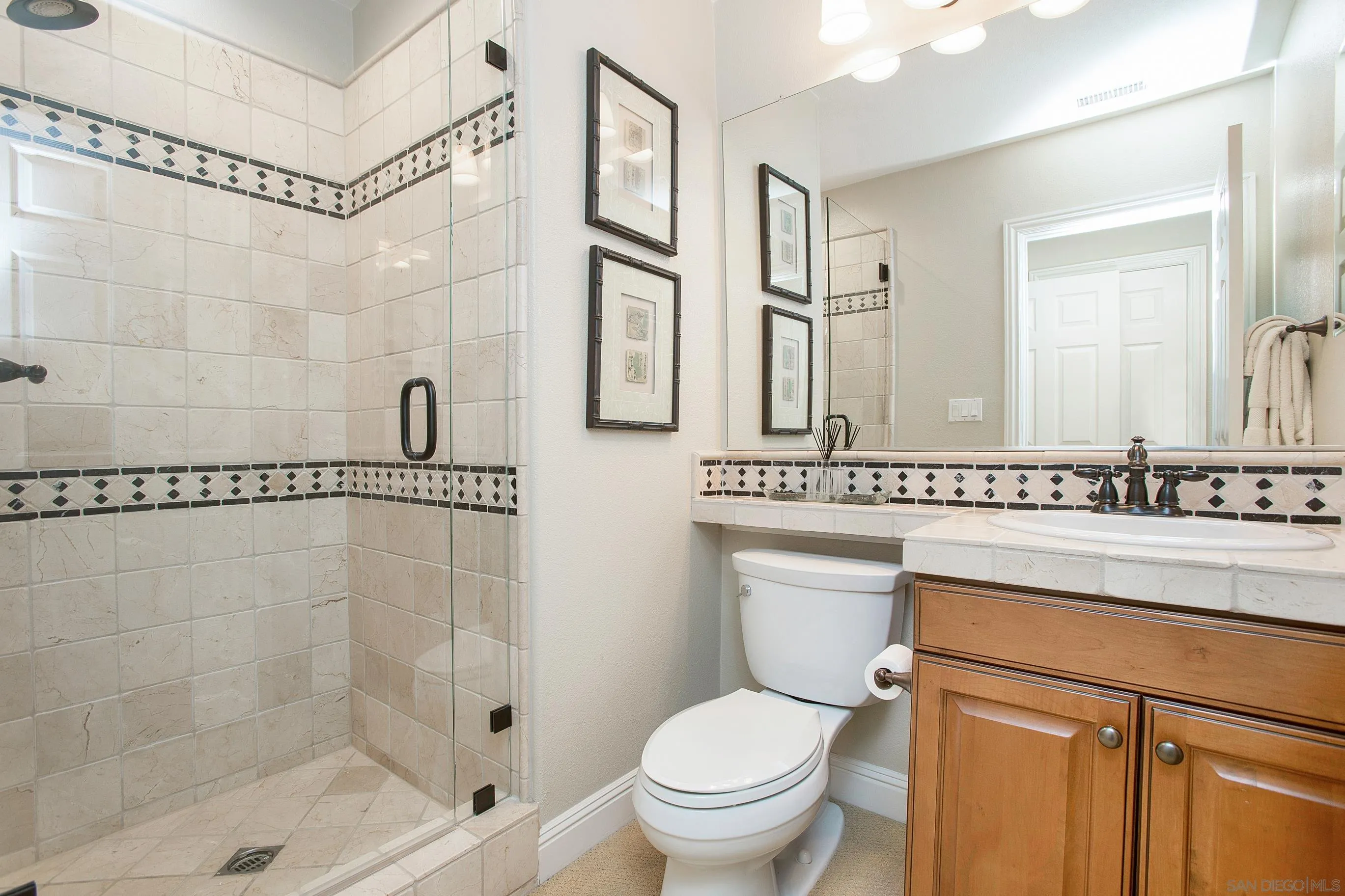 562 Shasta Drive Encinitas, CA 92024 - Photo 31 of 59 a bathroom with a shower sink vanity mirror and toilet