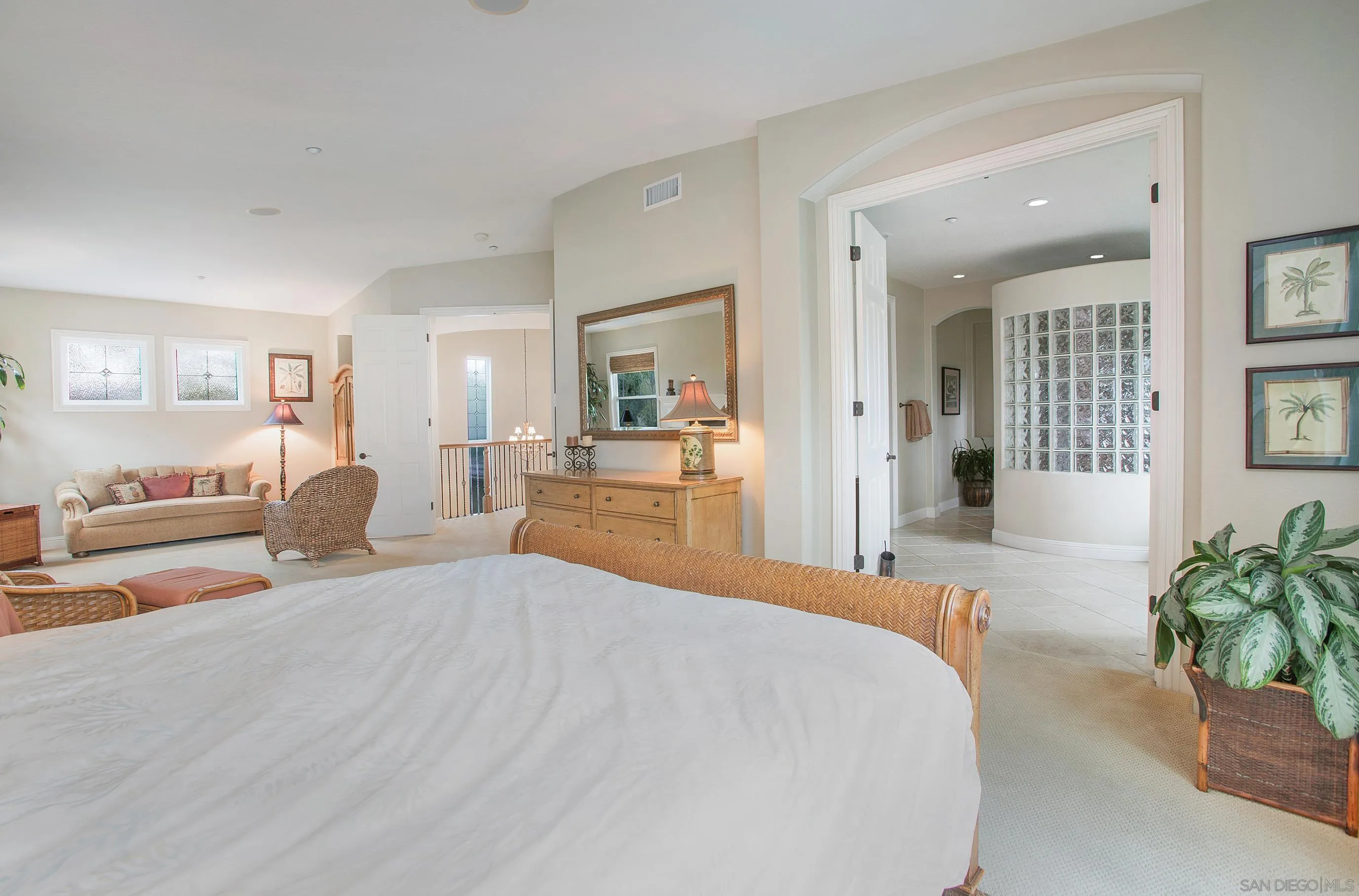 562 Shasta Drive Encinitas, CA 92024 - Photo 39 of 59 a large bedroom with a large bed with wooden floor and windows