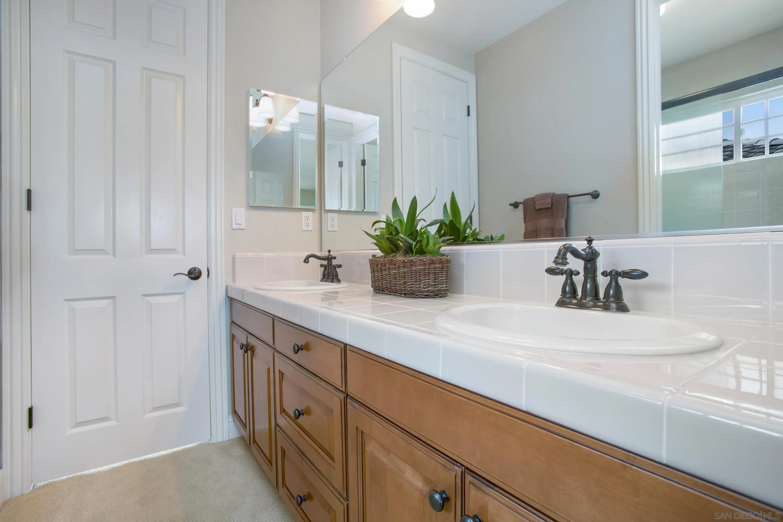 562 Shasta Drive Encinitas, CA 92024 - Photo 47 of 59 a bathroom with a sink and a mirror