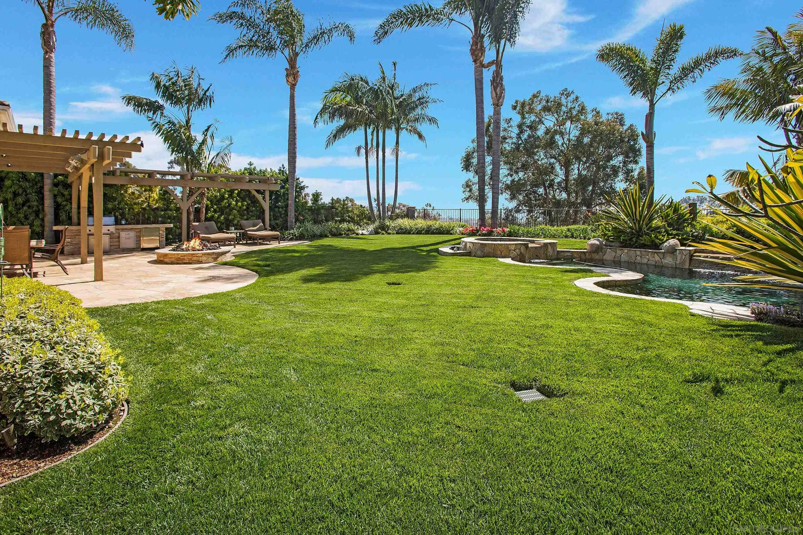 562 Shasta Drive Encinitas, CA 92024 - Photo 5 of 59 a view of a swimming pool with a table and chairs