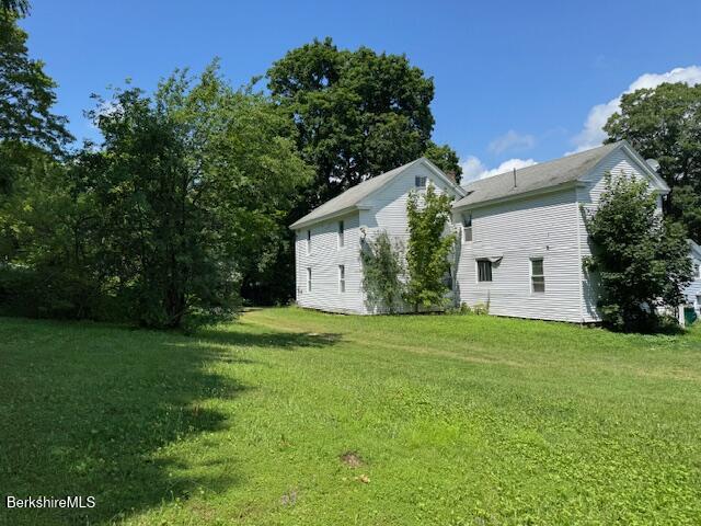 15 Golden Hill Road Lenox, MA 01242 - Photo 2 of 10 a view of a backyard with plants and large trees