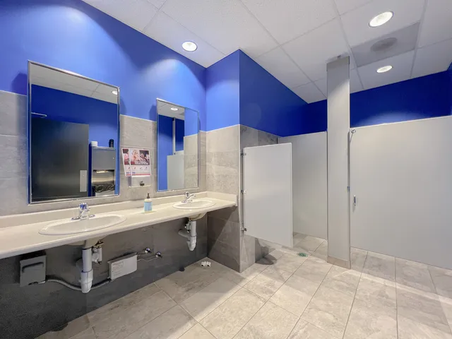 a bedroom with furniture and a large window