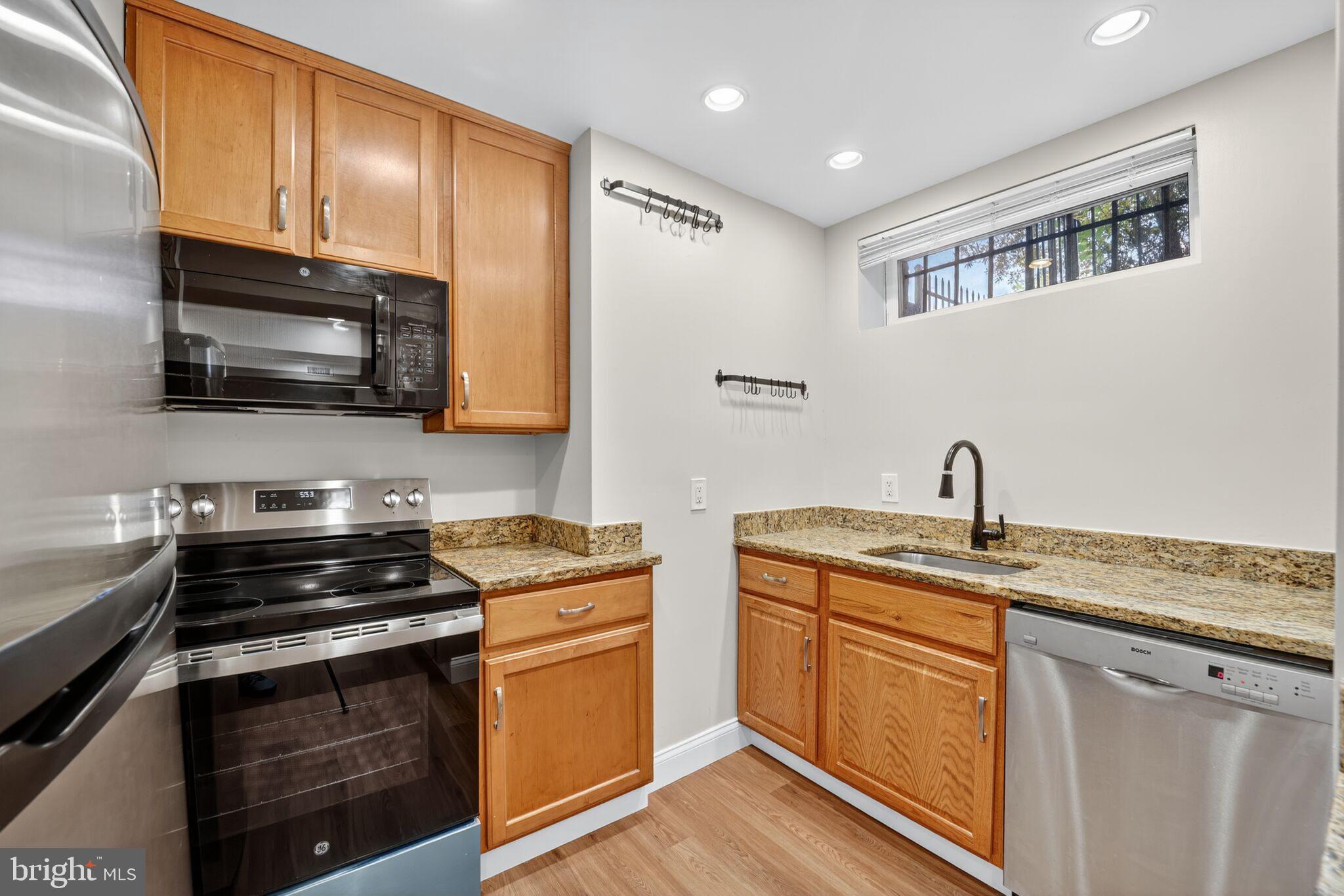 1000 Park Road Northwest Washington, DC 20010 - Photo 3 of 12 a kitchen with stainless steel appliances a stove sink microwave and cabinets