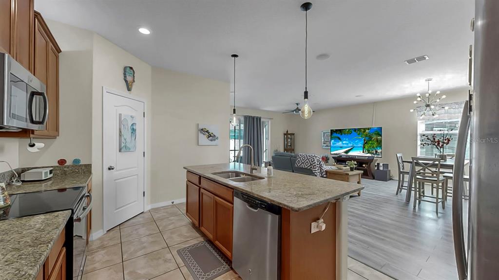 2408 Nighthawk Landing Court Ruskin, FL 33570 - Photo 17 of 50 a kitchen with sink cabinets and wooden floor