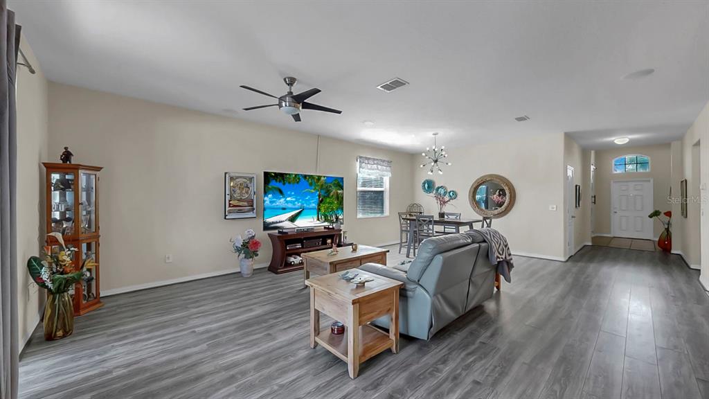 2408 Nighthawk Landing Court Ruskin, FL 33570 - Photo 20 of 50 a living room with furniture and a wooden floor