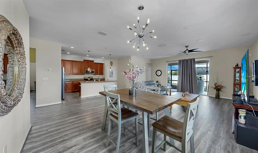 2408 Nighthawk Landing Court Ruskin, FL 33570 - Photo 21 of 50 a view of a dining room with furniture and wooden floor