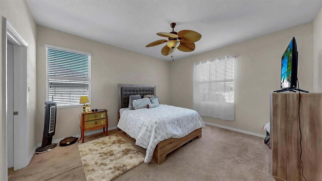 2408 Nighthawk Landing Court Ruskin, FL 33570 - Photo 23 of 50 a bedroom with a bed and a flat tv screen
