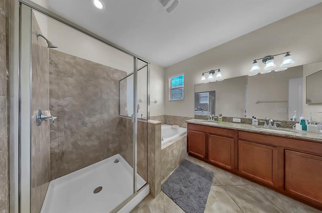 2408 Nighthawk Landing Court Ruskin, FL 33570 - Photo 25 of 50 a bathroom with a tub sink and mirror