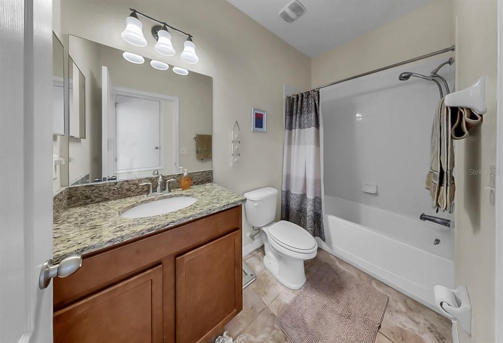 2408 Nighthawk Landing Court Ruskin, FL 33570 - Photo 29 of 50 a bathroom with a granite countertop sink toilet and shower
