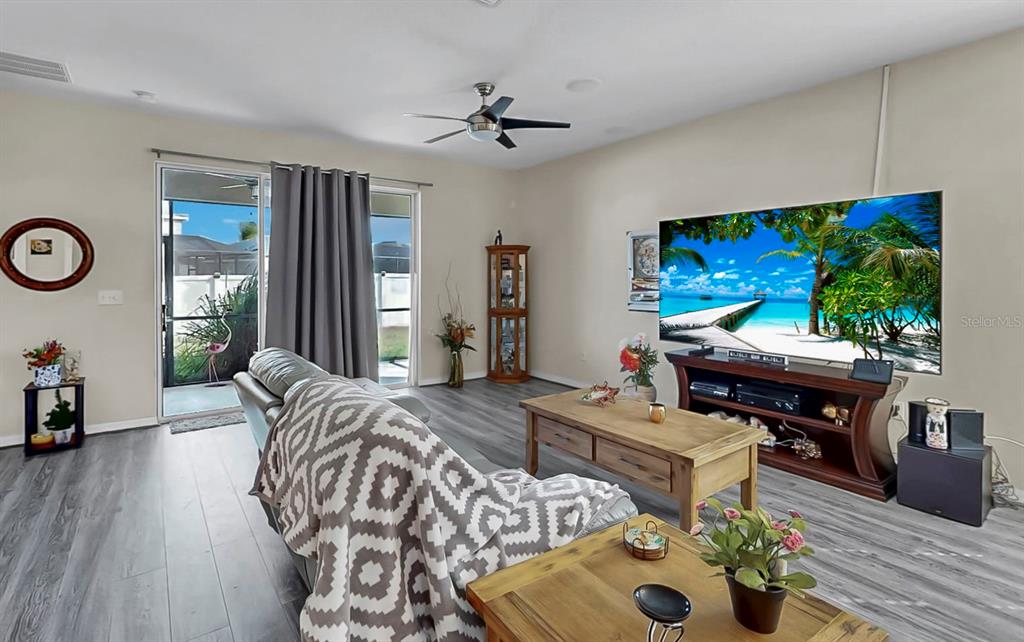 2408 Nighthawk Landing Court Ruskin, FL 33570 - Photo 3 of 50 a bedroom with furniture and a flat screen tv