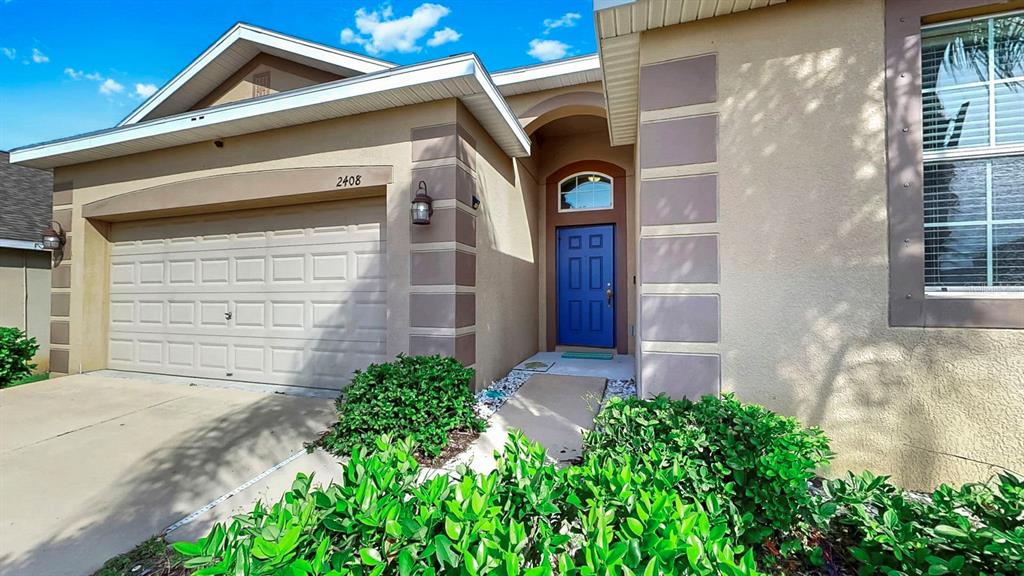 2408 Nighthawk Landing Court Ruskin, FL 33570 - Photo 33 of 50 a front view of a house with garden