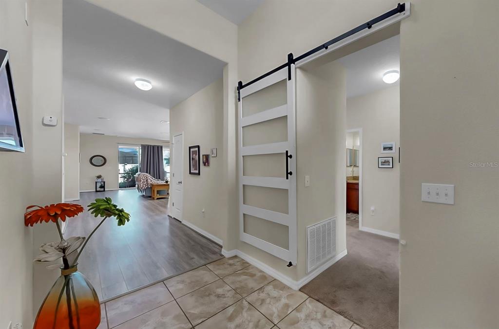 2408 Nighthawk Landing Court Ruskin, FL 33570 - Photo 5 of 50 a living room with furniture and a chandelier