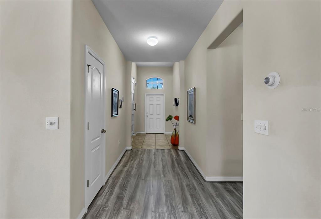 2408 Nighthawk Landing Court Ruskin, FL 33570 - Photo 8 of 50 a view of a hallway with wooden floor and staircase