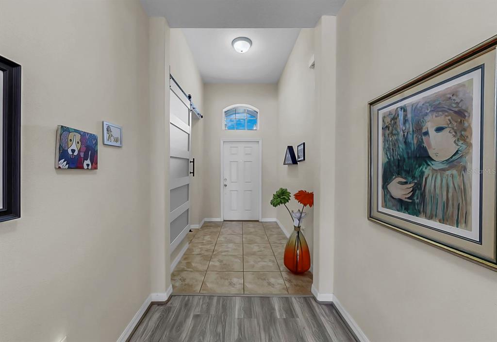 2408 Nighthawk Landing Court Ruskin, FL 33570 - Photo 9 of 50 a view of a hallway with wooden floor and closet