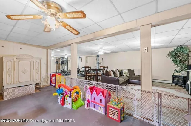 a living room with furniture and potted plants