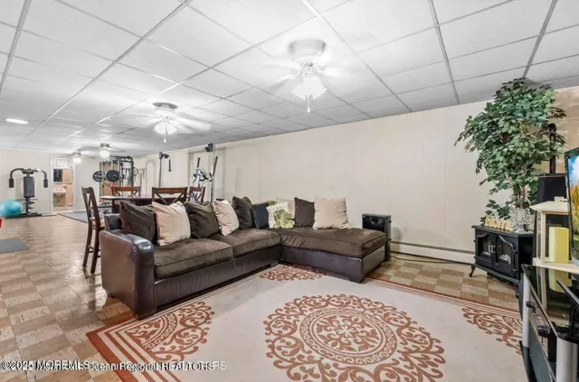 a living room with furniture and a chandelier