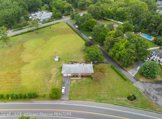 a view of a swimming pool with a yard