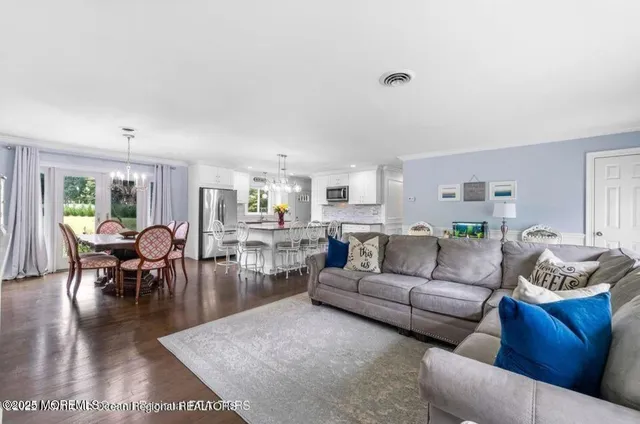 a living room with furniture wooden floor and a window