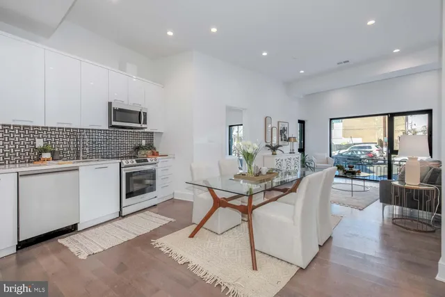 a view of a kitchen with kitchen island and stainless steel appliances