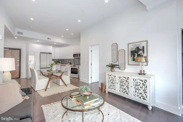 a living room with furniture a dining table and kitchen view