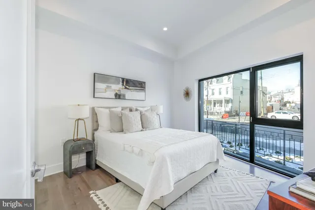 a bedroom with a large bed and a night stand