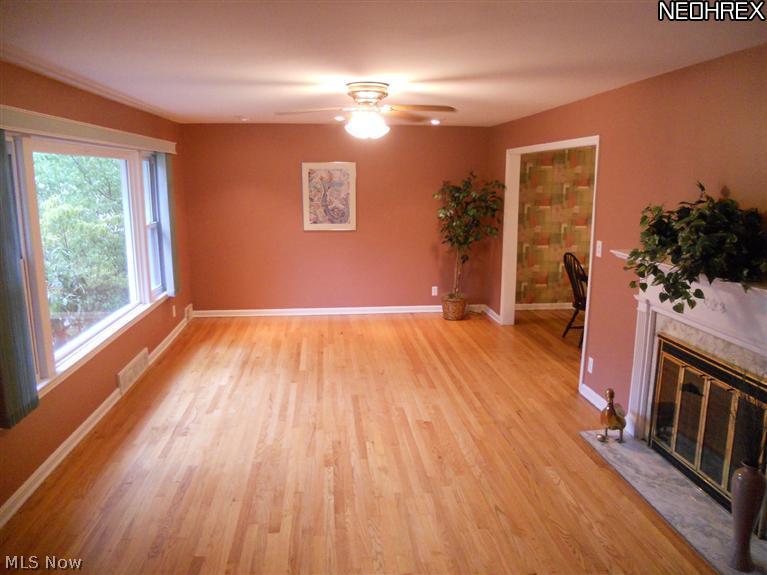 1945 Temblethurst Road South Euclid, OH 44121 - Photo 2 of 15 Living Room with Gorgeous Refinished Hardwood Floors and Wood Burning Fireplace