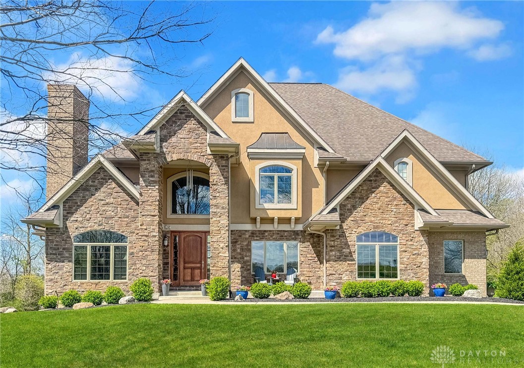 4096 Middle Urbana Road Urbana, OH 43078 - Photo 1 of 96 This grand residence showcases a captivating facade with stone and stucco, set against a vibrant green lawn.