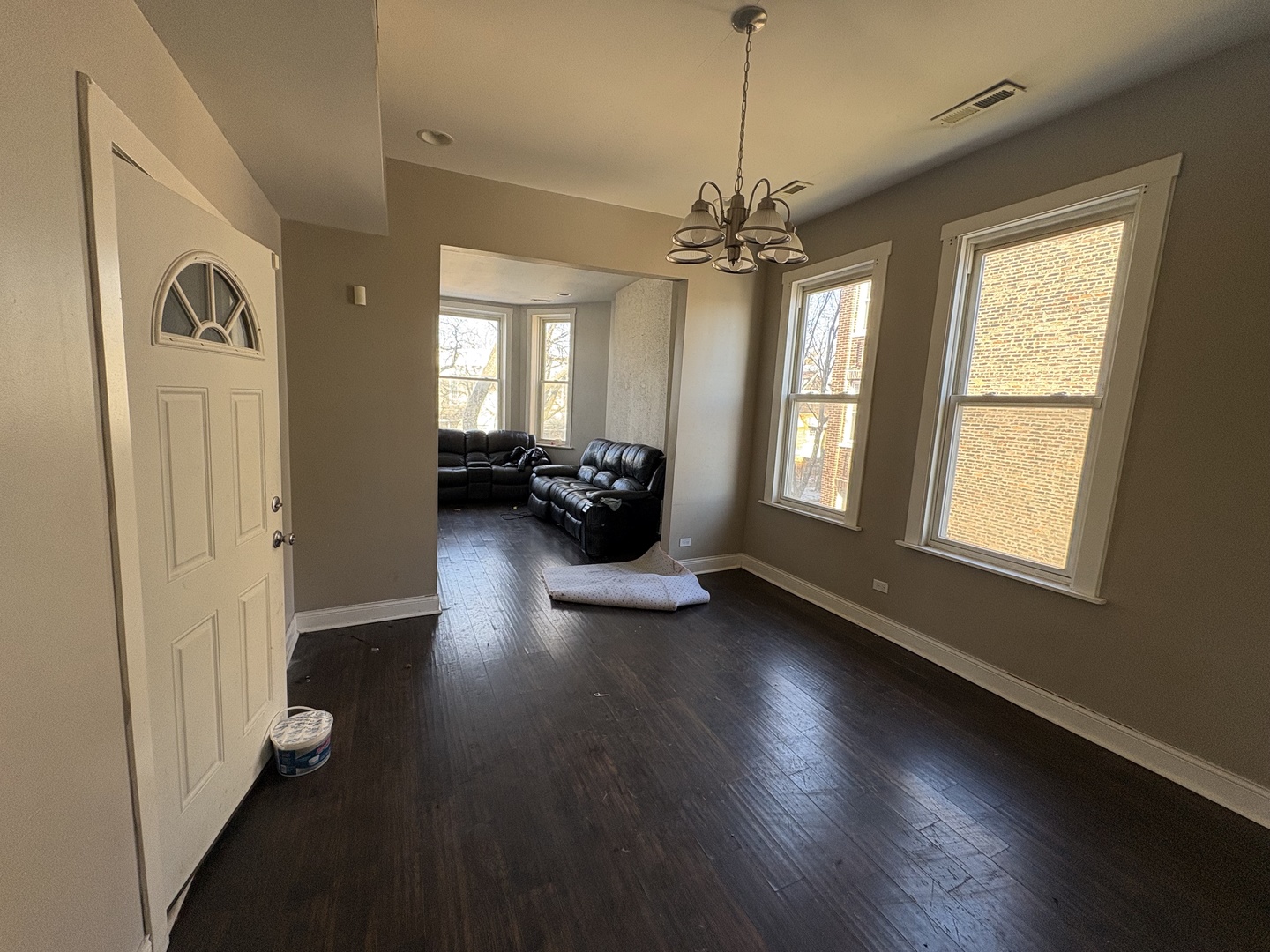 3843 West Fillmore Street Chicago, IL 60624 - Photo 12 of 38 a view of a livingroom with furniture hardwood floor and a ceiling fan