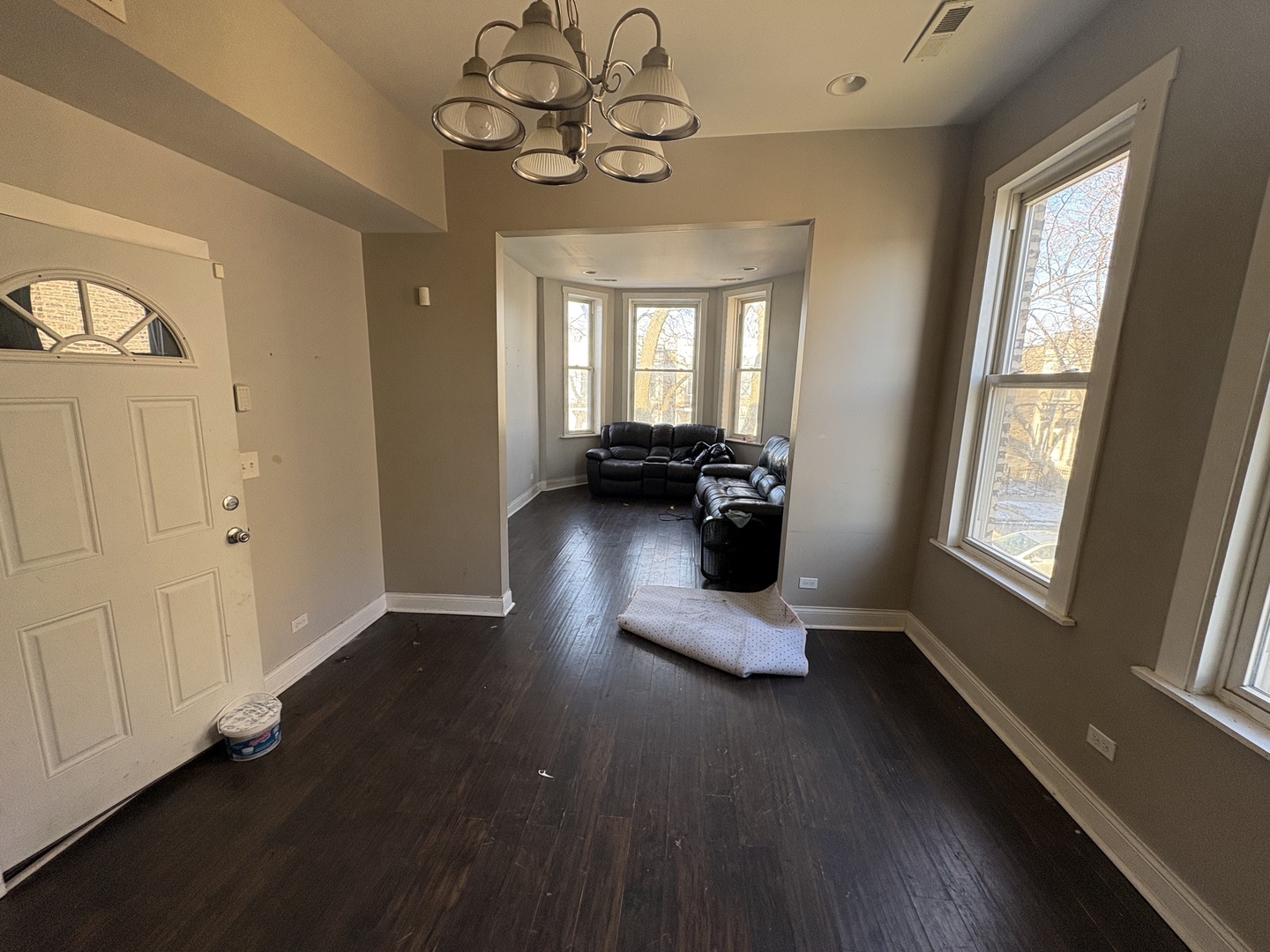 3843 West Fillmore Street Chicago, IL 60624 - Photo 15 of 38 a view of a livingroom with furniture wooden floor and windows