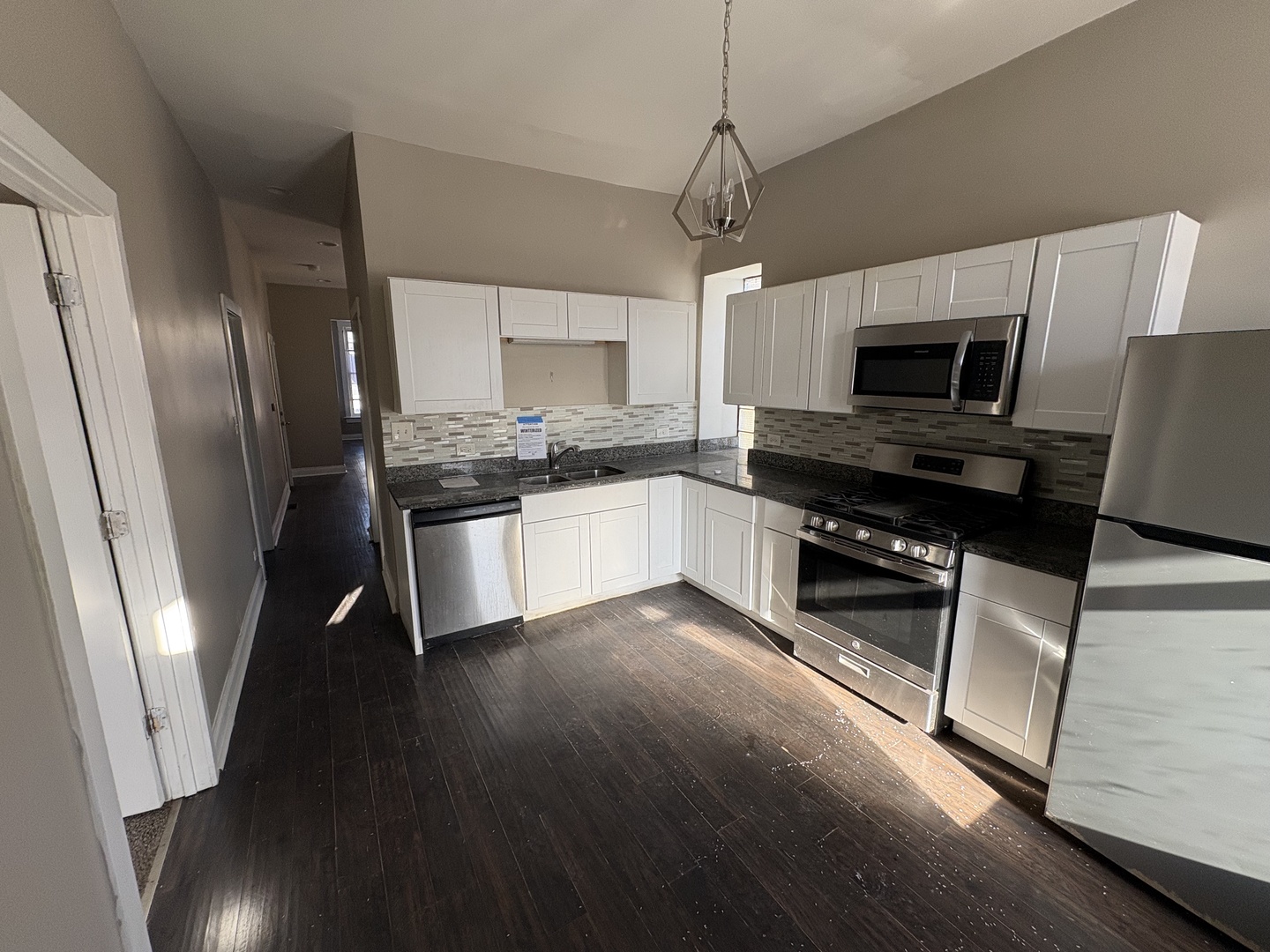 3843 West Fillmore Street Chicago, IL 60624 - Photo 23 of 38 a kitchen with stainless steel appliances a stove refrigerator and microwave