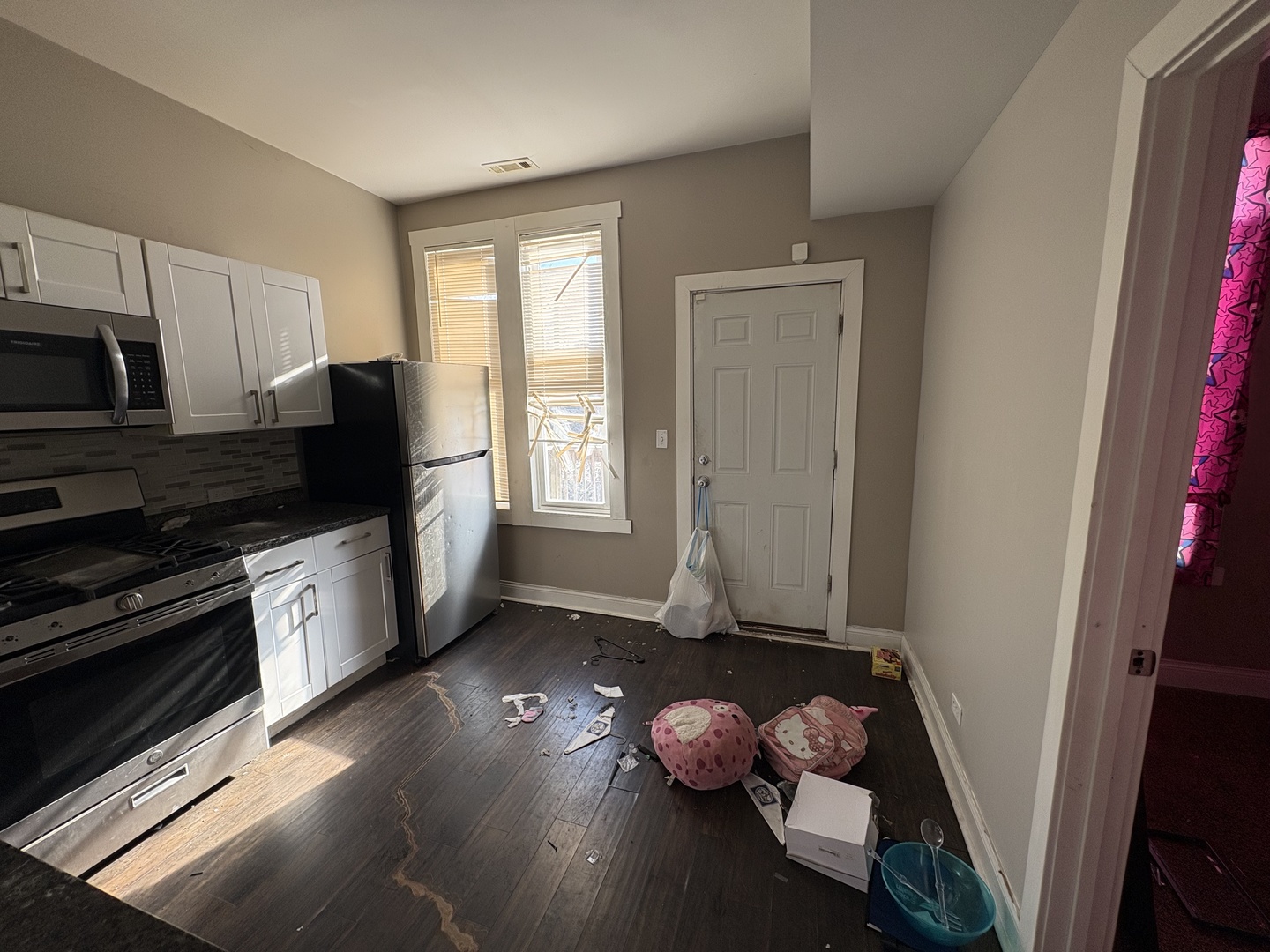 3843 West Fillmore Street Chicago, IL 60624 - Photo 4 of 38 a kitchen with wooden floors and appliances