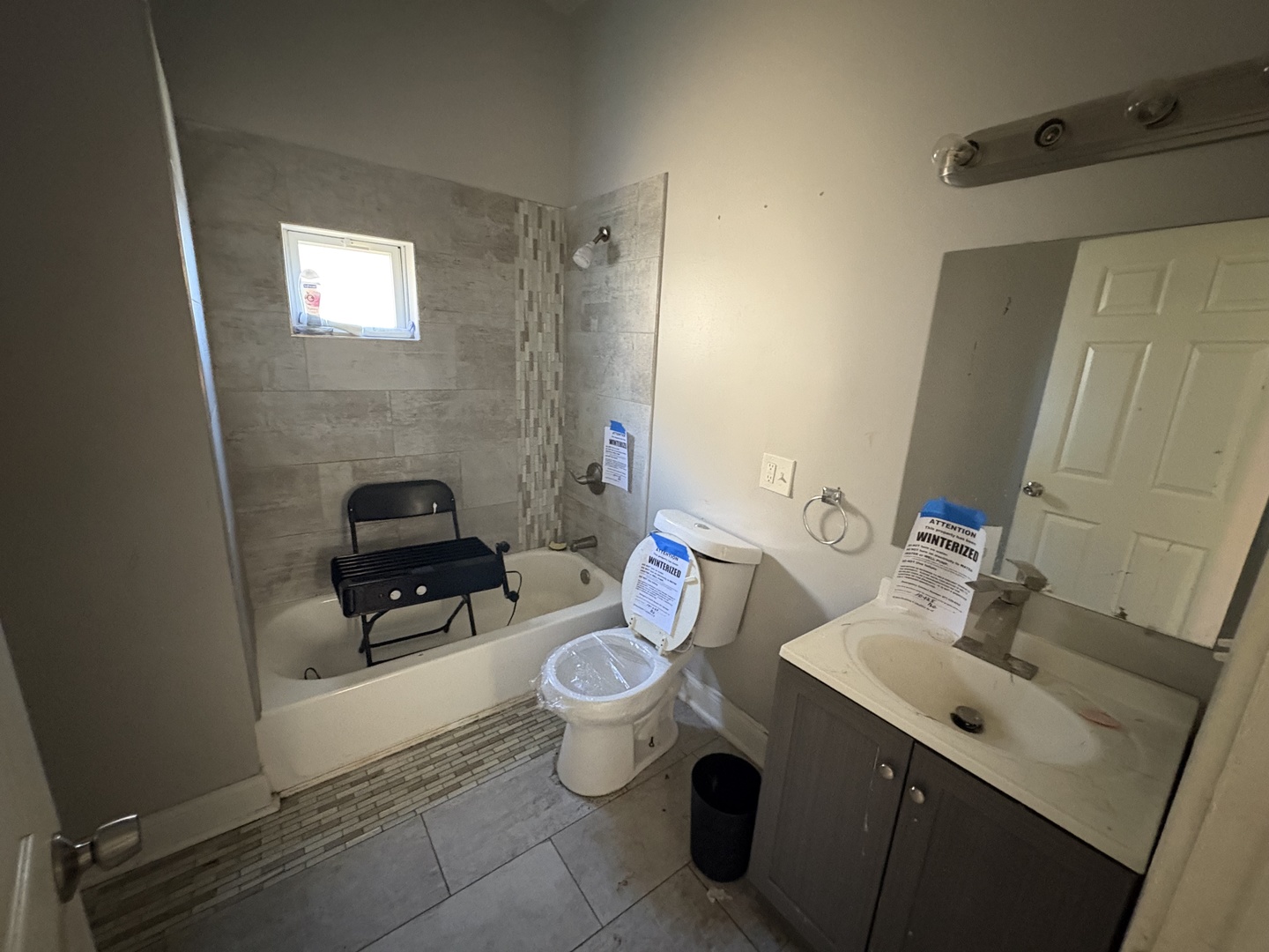 3843 West Fillmore Street Chicago, IL 60624 - Photo 8 of 38 a white toilet sitting next to a bathroom sink and a mirror